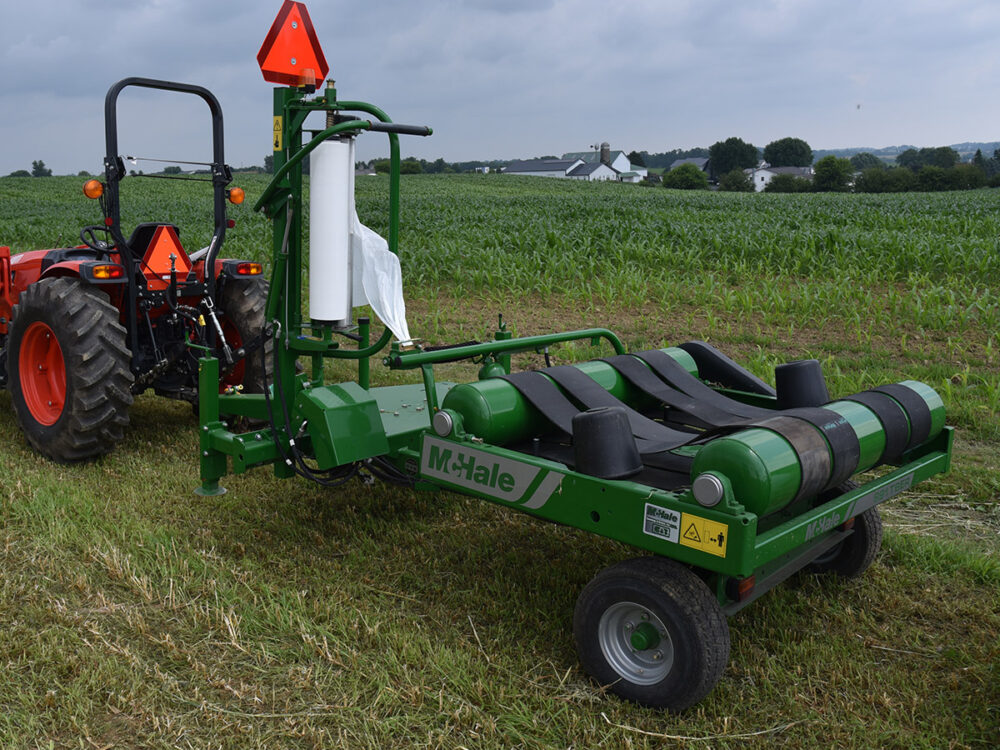 New McHale 991TBER bale wrapper fully remote operated, trailer unit, no lift arm, and equipped with an electric remote.