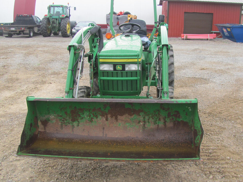 Used John Deere 3005 tractor with front-end loader, rotted front tires, and 613 hours, in fair condition.