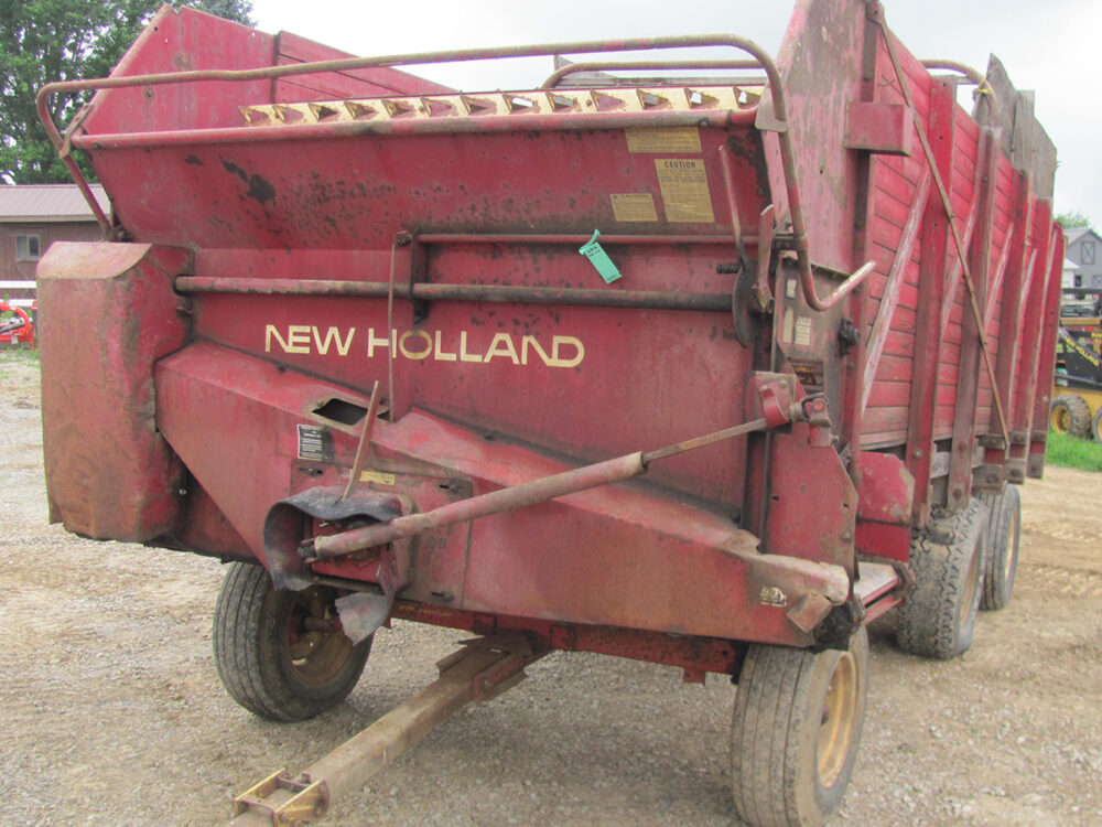 Used 8-ton New Holland forage wagon with low tires in fair condition.
