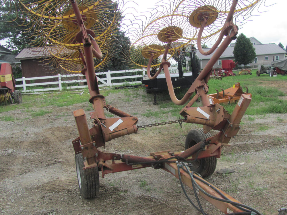 Used 8-wheel Haymaker #1 wheel rake with a hydraulic lift in fair condition.