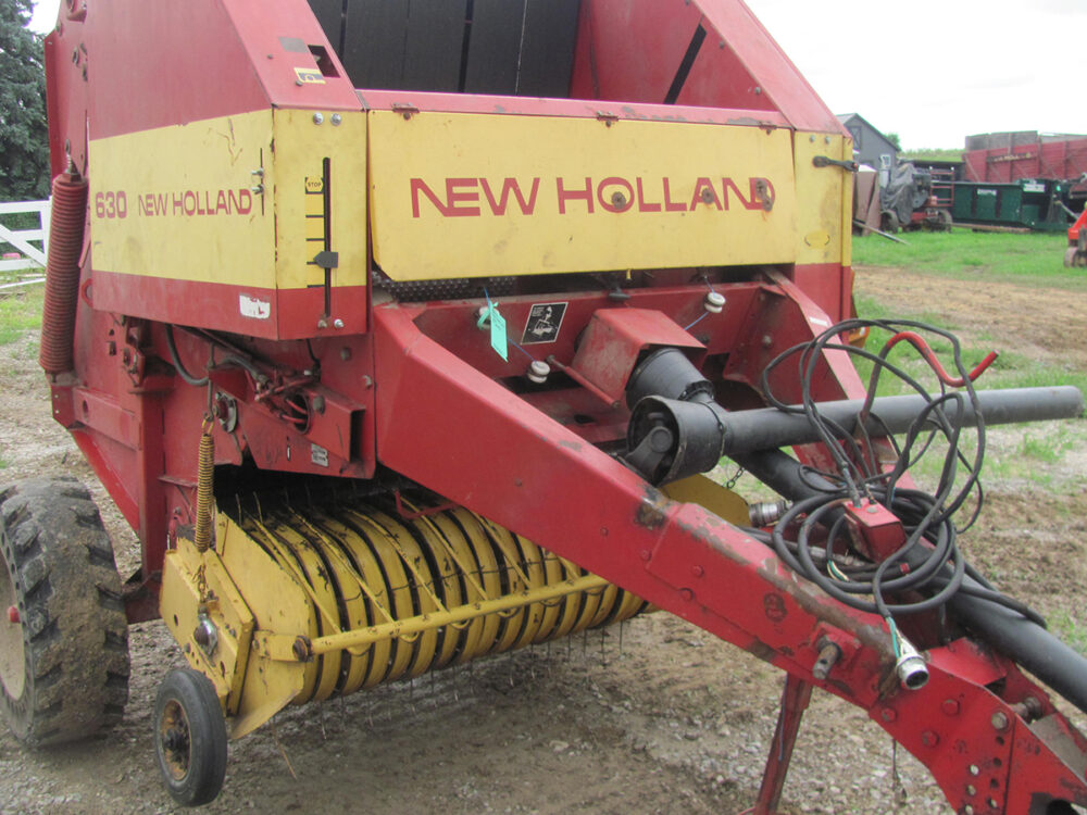 Used 4x4 New Holland 630 round baler with twine and air boss wheels, in working condition.