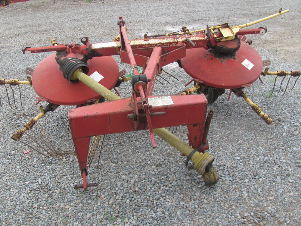 Used 3-point New holland 254 tedder rake in working condition.