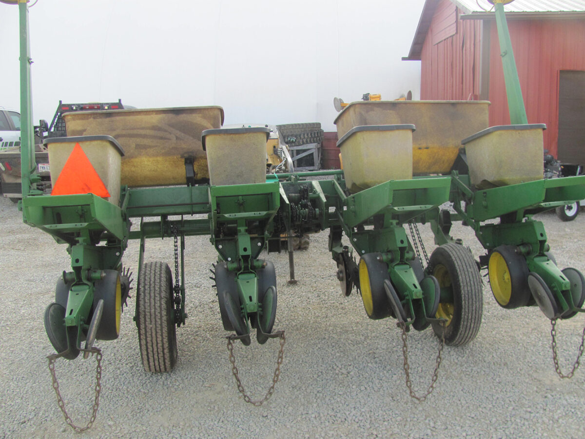 Used John Deere 4-row corn planter, conventional with row cleaners, dry fertilizer hoppers, hydraulic lift, in good condition but missing fertilizer hopper lids.