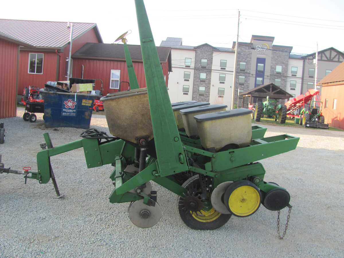 Used John Deere 4-row corn planter, conventional with row cleaners, dry fertilizer hoppers, hydraulic lift, in good condition but missing fertilizer hopper lids.