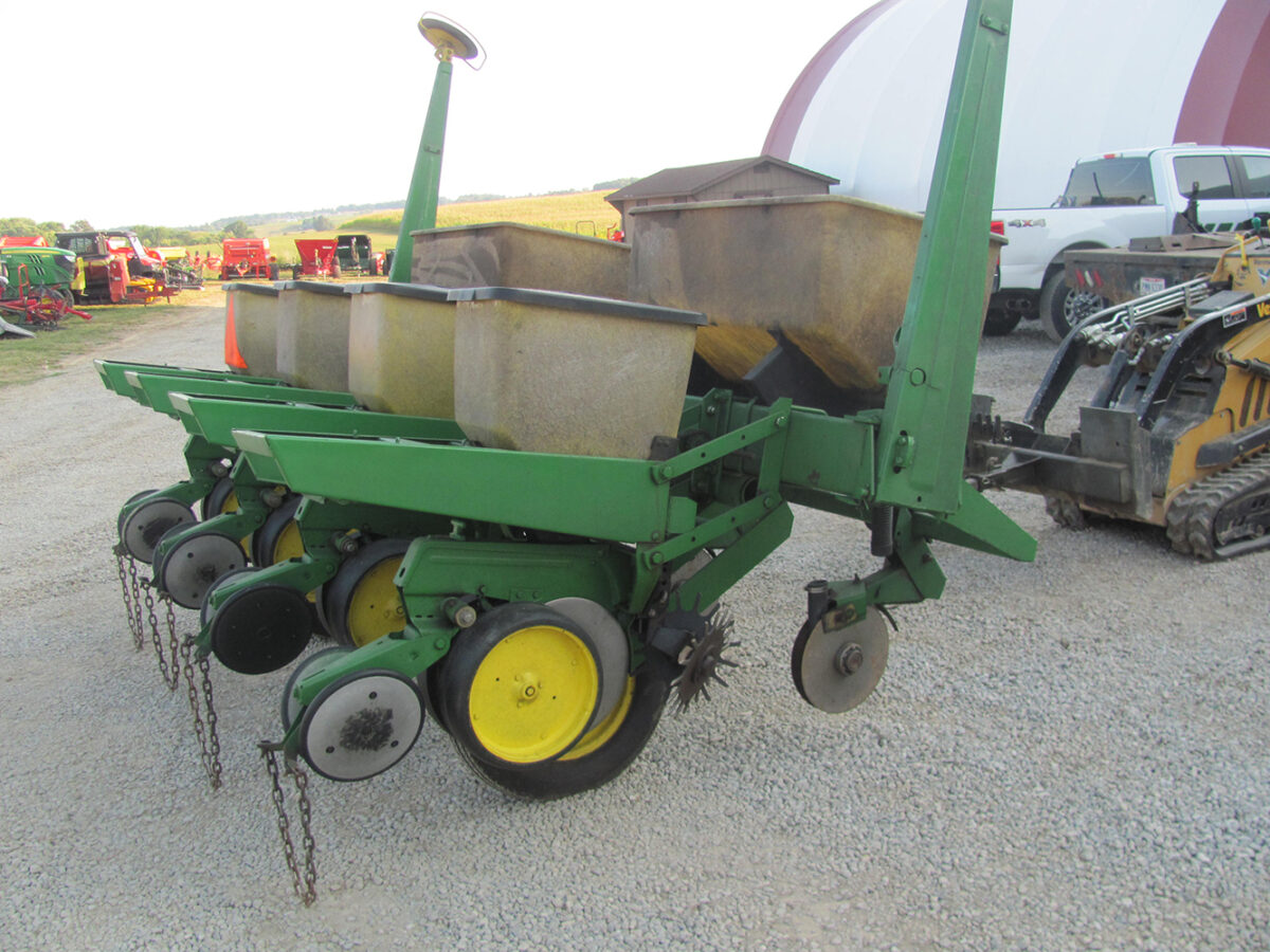 Used John Deere 4-row corn planter, conventional with row cleaners, dry fertilizer hoppers, hydraulic lift, in good condition but missing fertilizer hopper lids.