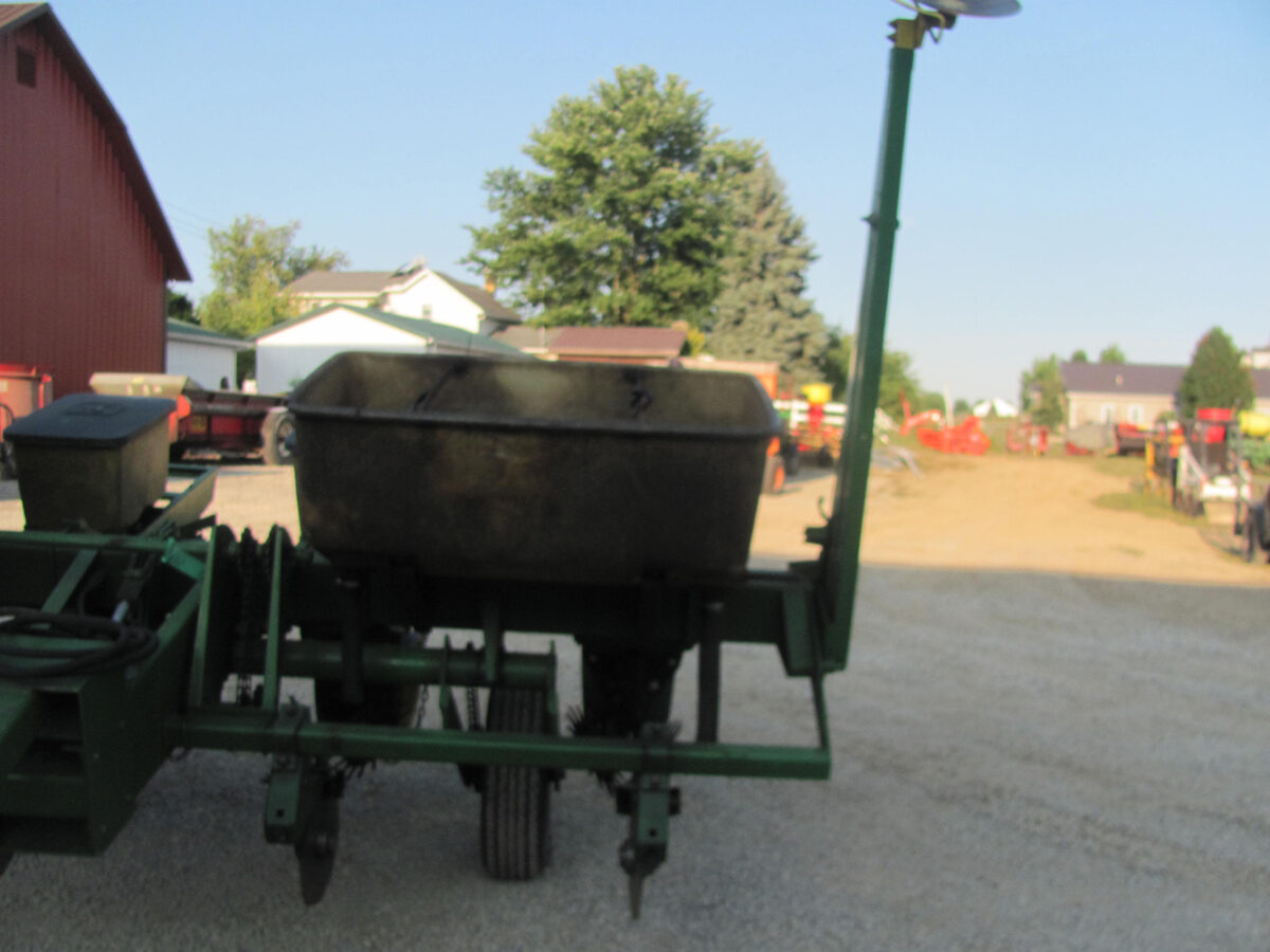 Used John Deere 4-row corn planter, conventional with row cleaners, dry fertilizer hoppers, hydraulic lift, in good condition but missing fertilizer hopper lids.