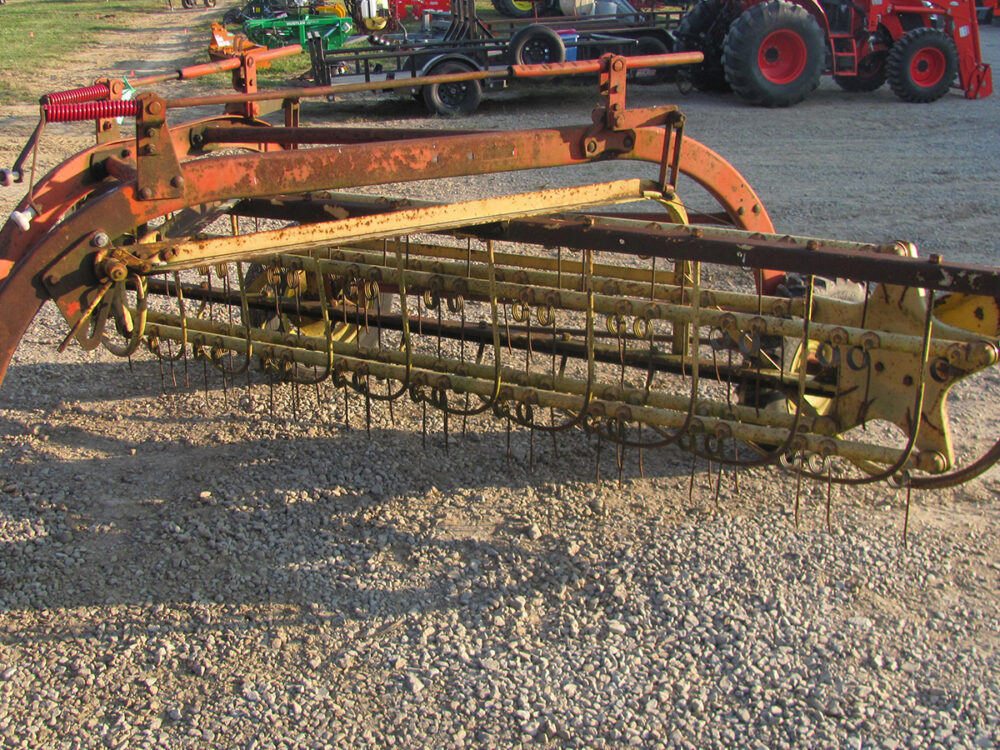 Used New Holland 256 Rolabar rake with air tires and steel tines, in good working condition, no dolly.