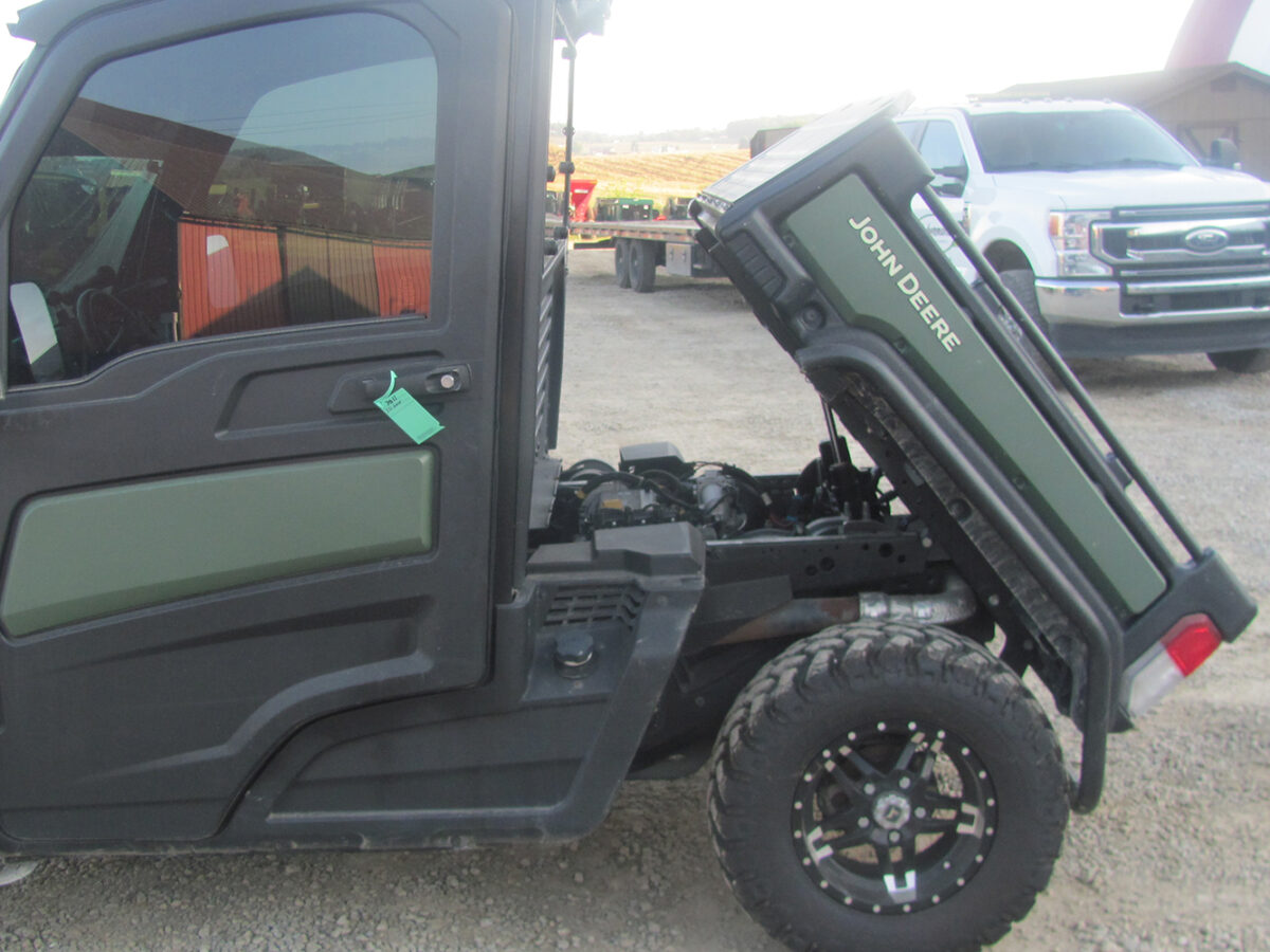 Used 2022 John Deere Gator XUV835M UTV with 4x4, cab, AC/heat, gas engine, radio, winch, power dump bed, 2,496 miles, 496 hours, serial #1M0835MDTN050674 — a nice, clean unit.