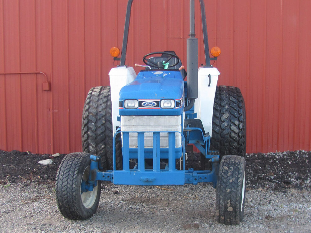 Used Ford 1920 tractor with 6,041 hours, serial #UP22205, starts easily, and equipped with a front grill guard and hitch.