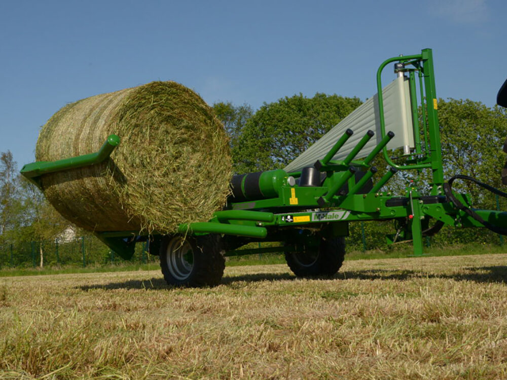 New McHale 991 BC bale wrapper with trailer and side tip, featuring 4-lever cable controls.