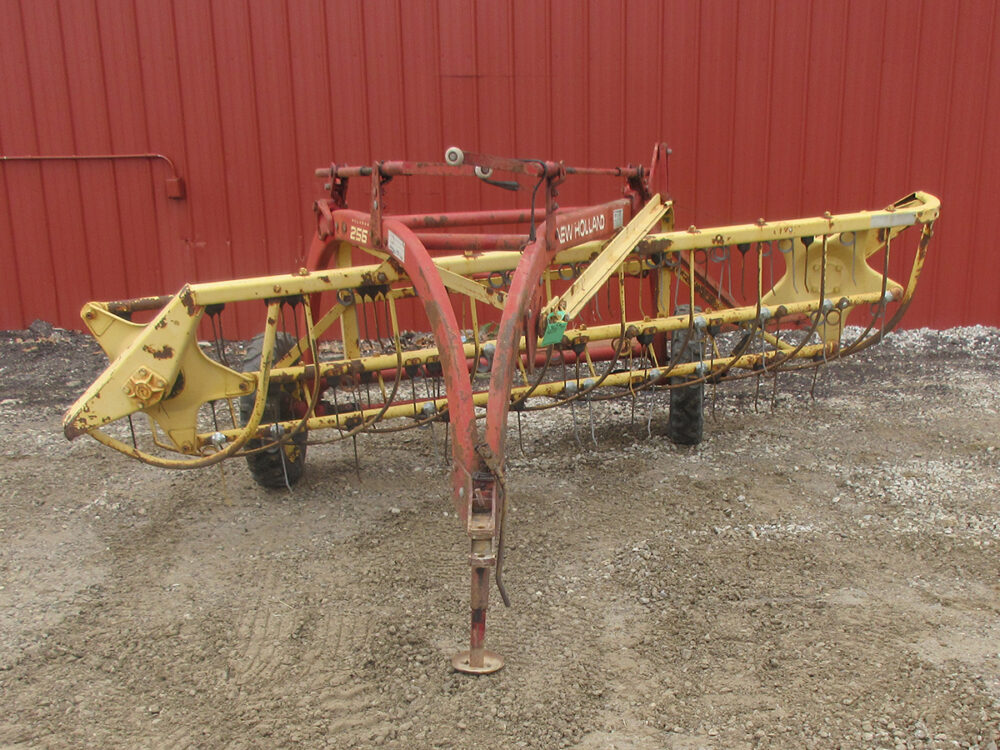 Used New Holland 256 Rolabar rake in working condition with serial #765564.