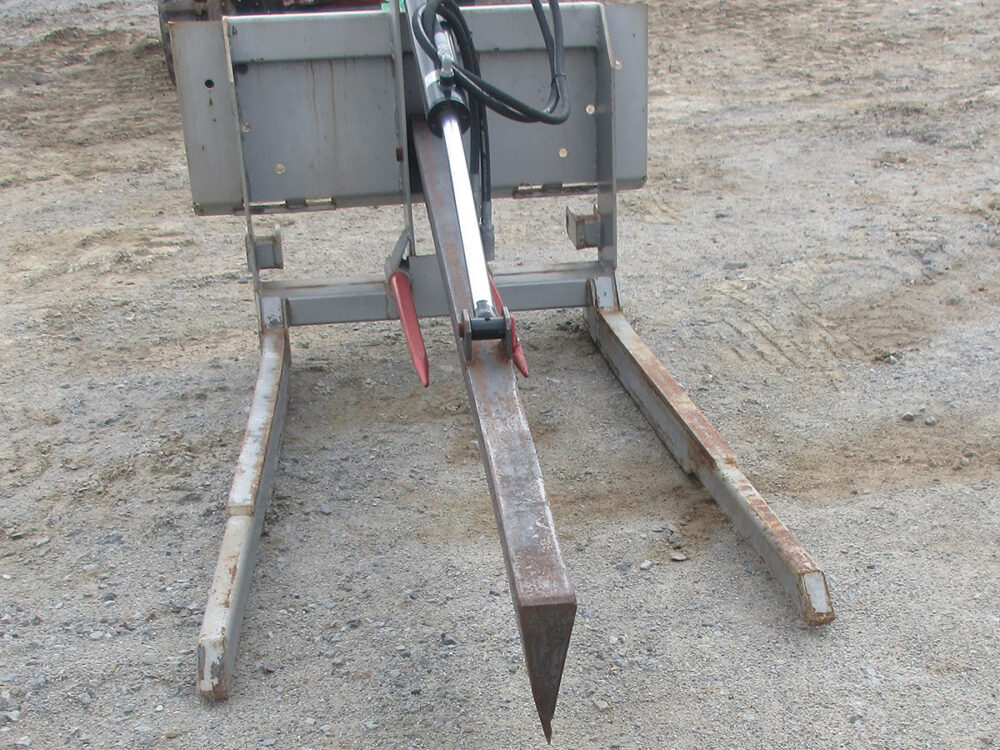 Used bale knife with 3-point or skid loader mount, hydraulically cuts 4x4 or 5x5 bales.