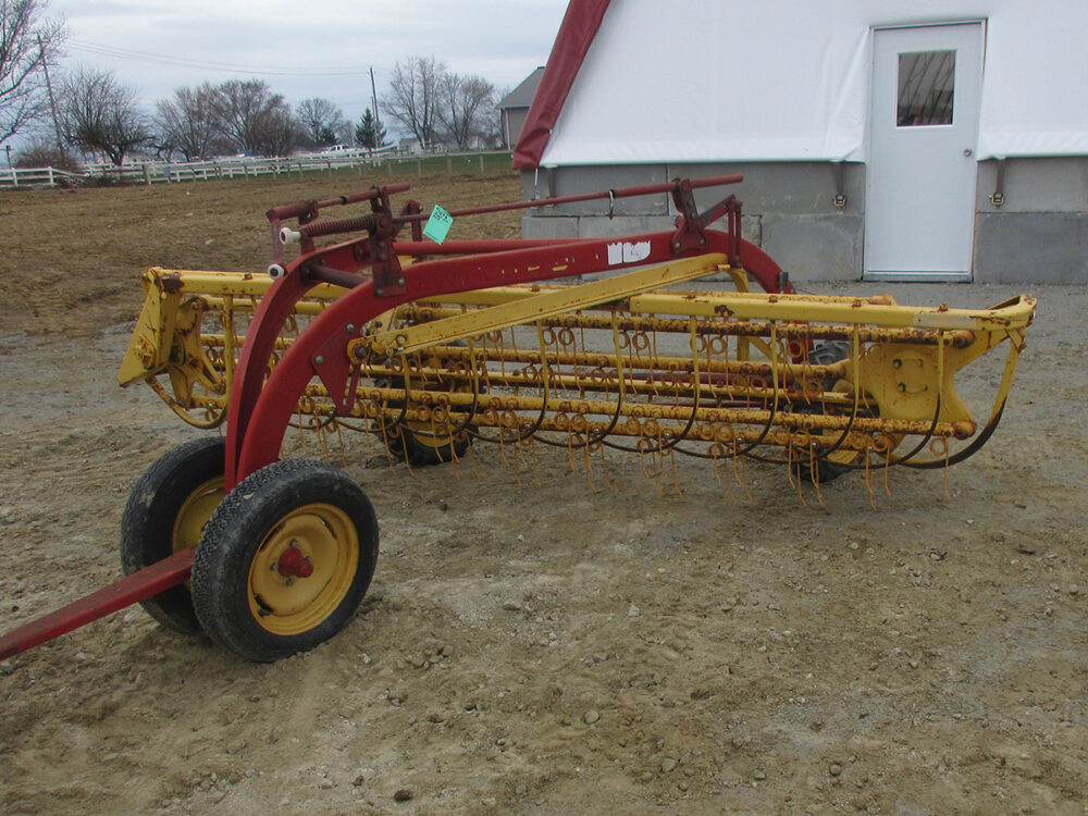Used New Holland 258 Rolabar rake with steel spring teeth, excellent condition, and serial #822501.