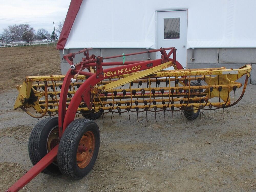 Used New Holland 258 Rolabar rake with rubber teeth, excellent condition, and serial #610740.