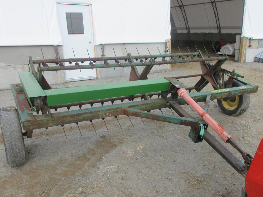 Used Pequea 910 tedder in good condition with fair paint, PTO latch is missing.