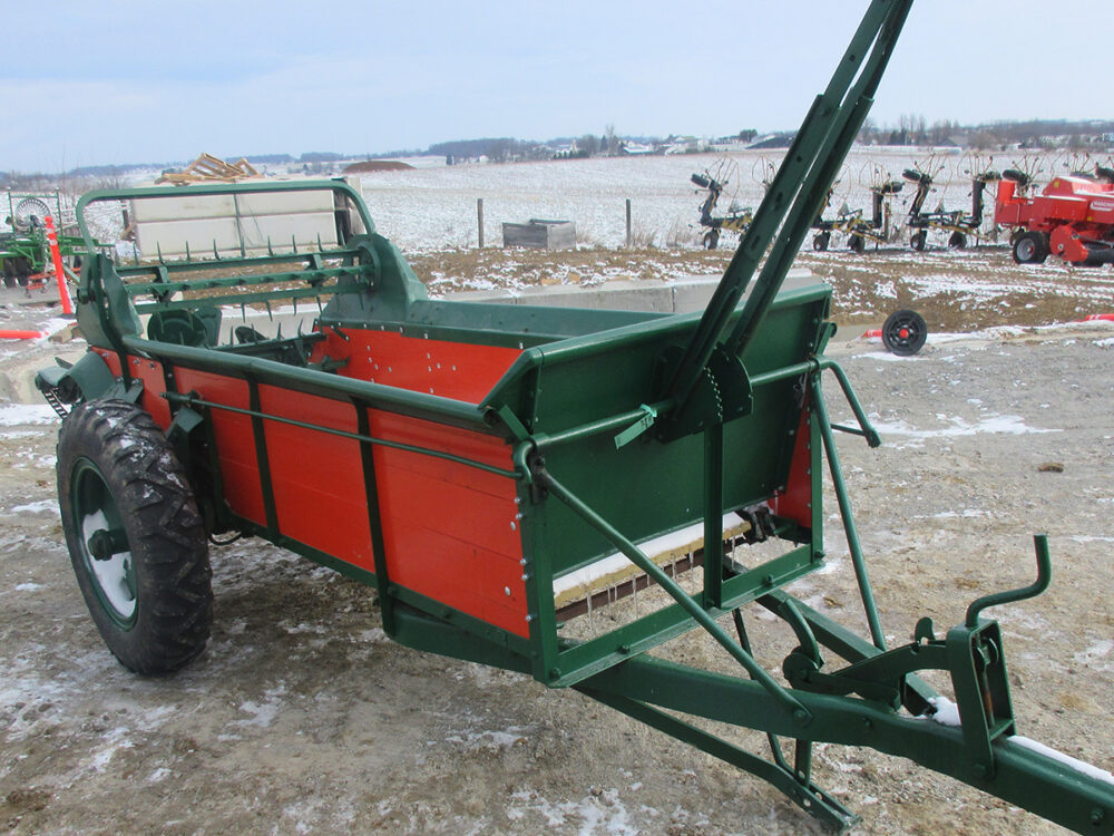 Used New Idea 18 manure spreader rebuilt with new wood, 95-bushel capacity, and serial #G4548.