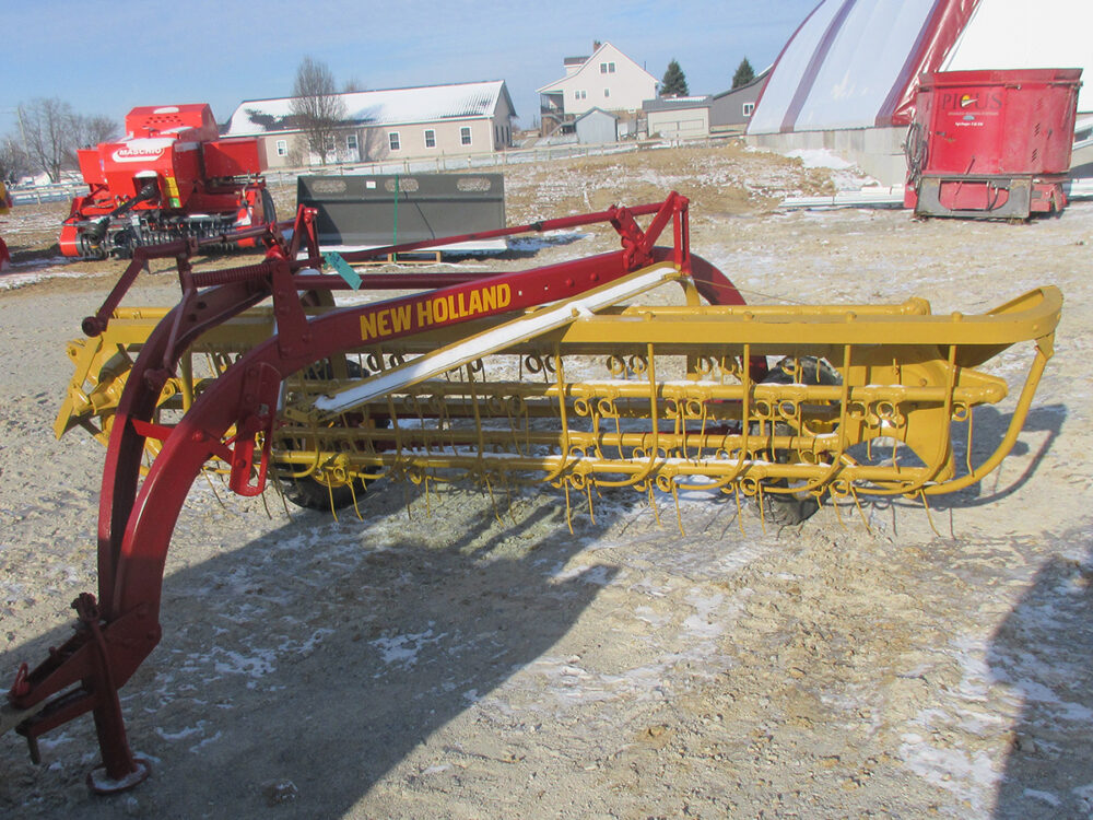 Used New Holland 56 Rolabar rake field ready, painted, and serial #42054.
