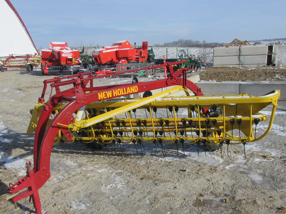 Used New Holland 256 Rolabar rake with rubber teeth, field ready, painted, and serial #453002.