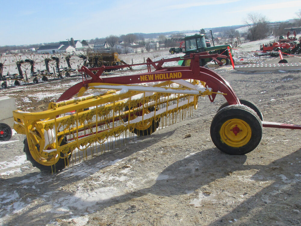 Used New Holland 260 Rolabar rake field ready, painted, with dolly, and serial #566633.