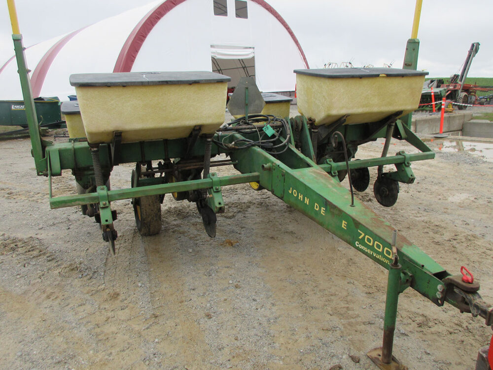 Used John Deere 7000 Conservation corn planter with 4 rows, no-till setup, dry fertilizer, corn and bean plates, monitor, 32" row spacing, stored inside, good condition, and serial #103457-A.