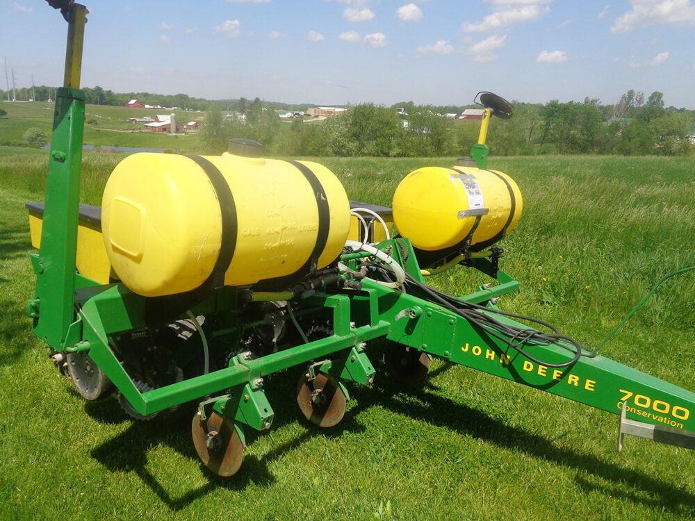 Used John Deere 7000 corn planter with 4 rows, liquid fertilizer, row cleaners, row markers, pull-type design, hydraulic cylinder, and in excellent condition. All replaceable parts were replaced within the last 120 acres.