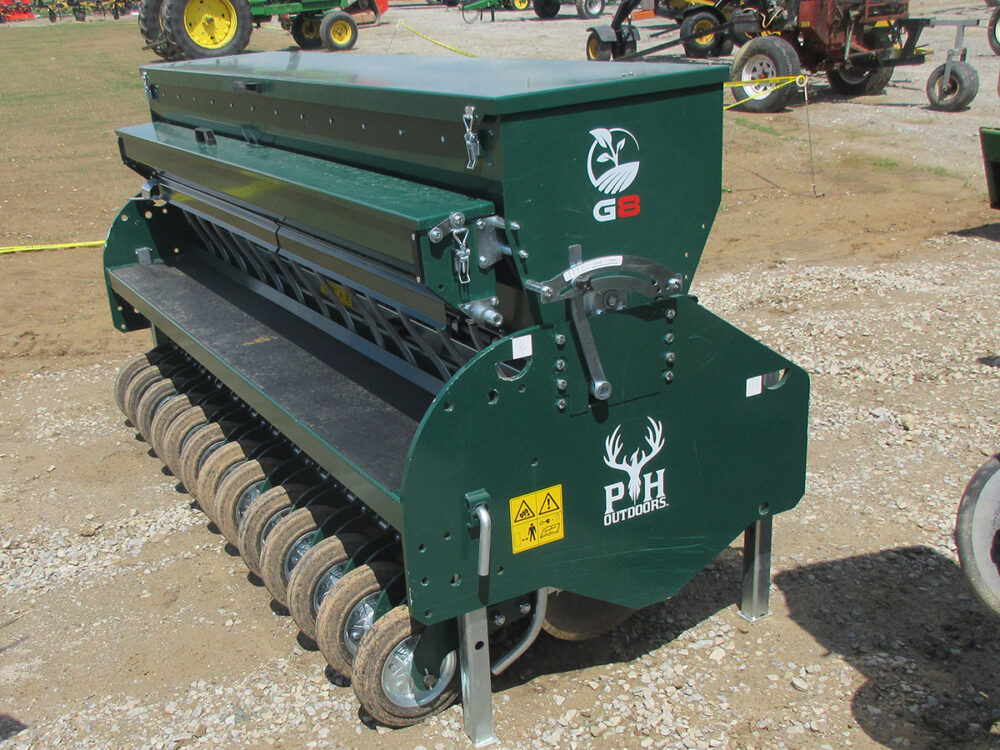 Used PH Outdoors Genesis 8 drill with 96" working width, 13 rows on 7.5" spacing, 3-point hookup, 12-bushel box, includes small seed box and 12 hopper divider plates, and serial #258206.