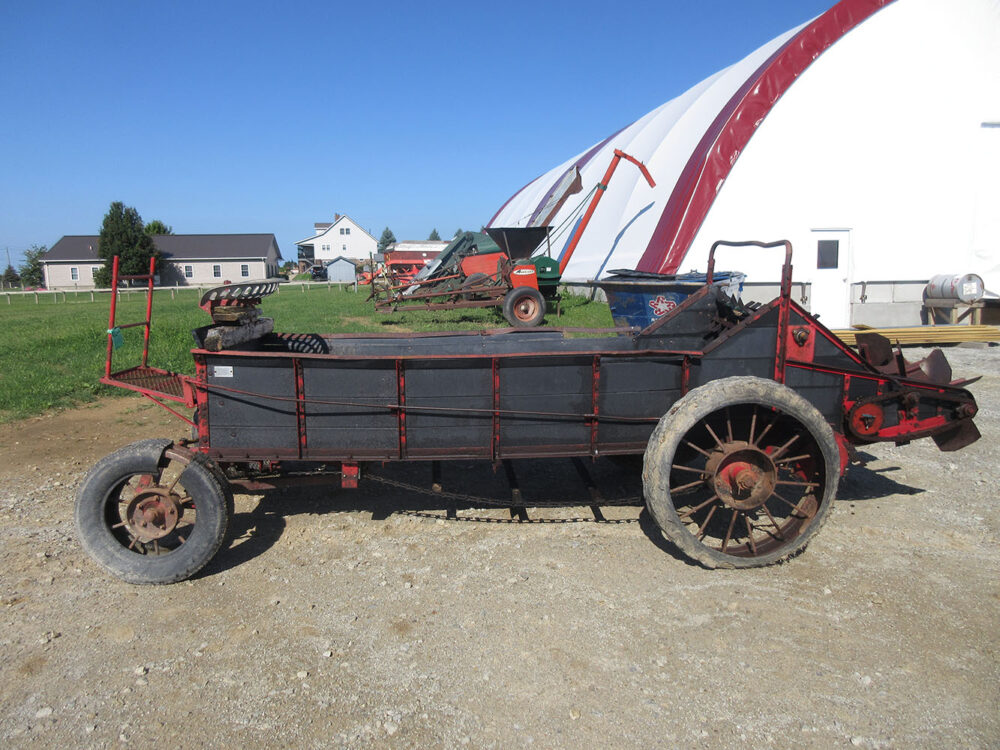 Used equipment: 4-wheel manure spreader with steel wheels and rubber, some new bearings, less tongue, broken sideboards, bent top beaters, and in rough condition, serial number 75100410126