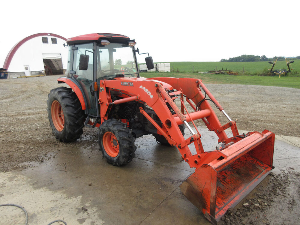 Used Kubota L5240 tractor with cab, serial #30290, 54hp, 4wd, hydro with Stall Guard, Ag tires, loader with bucket, 2 working hydraulics, working 3-point and PTO, and good oils. Rough condition, screen and one mirror are broken, top of front frame is broken, interior is in fair condition, right-side front-facing lights do not work, and one side door is missing the glass.