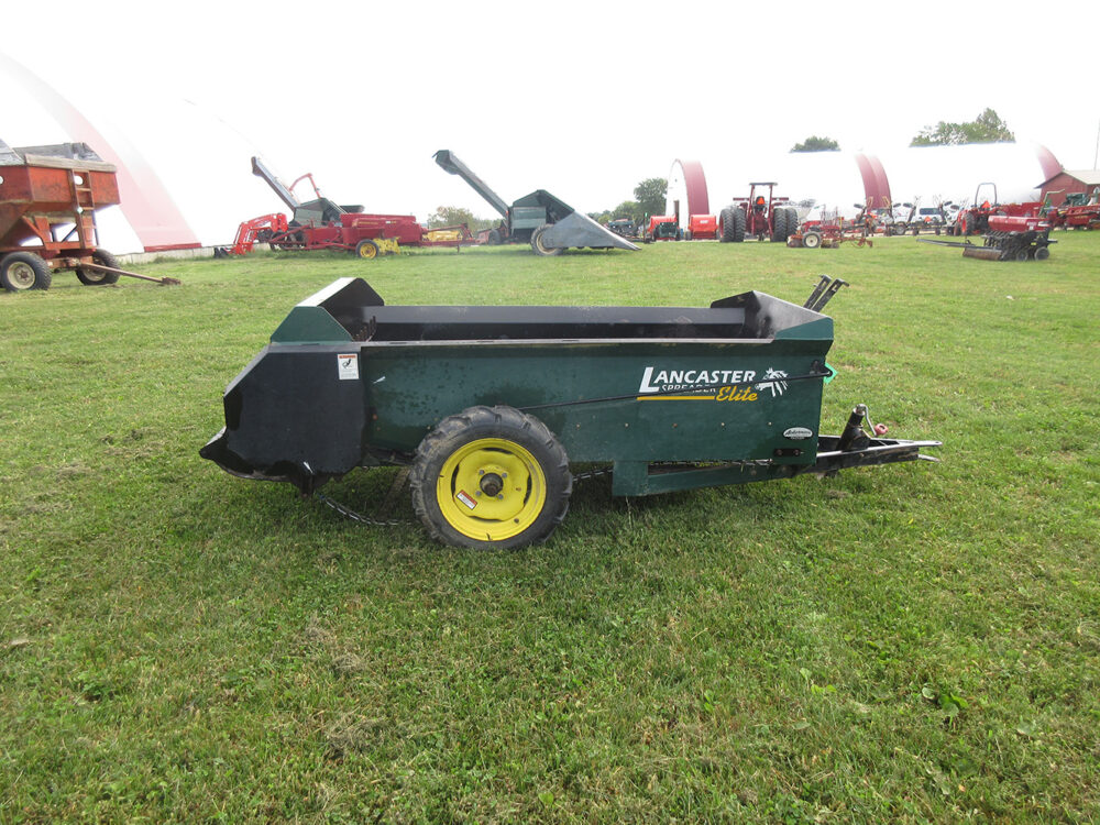 Used equipment: Lancaster 50-bushel manure spreader with litter pan, air tires, and stainless steel web, one slat needs replaced, some rust, in great working condition, serial number 1510