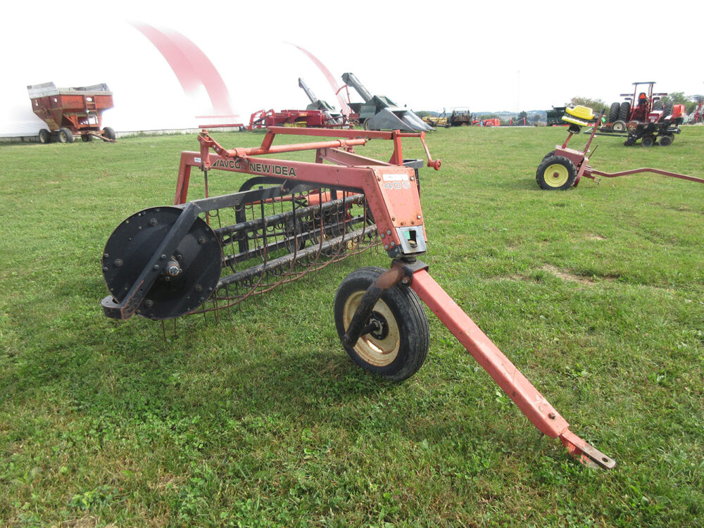 Used equipment: New Idea 405 Rolabar rake with dolly and belt drive, has a few broken teeth, in fair condition, serial number R178581